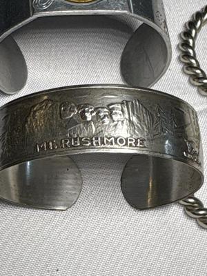 Sale Photo Thumbnail #64: Lucky horseshoe/shamrock & 1945 wheat penny bracelet, Mt Rushmore bracelet & 2 silver bracelets