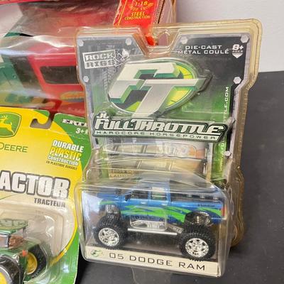 LOT 125: Various Vehicle Toys in Original Packaging - John Deere, Tonka and More