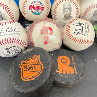 LOT 183: Philadelphia Sports Collection - Phillies Baseballs, Flyers Hockey Pucks