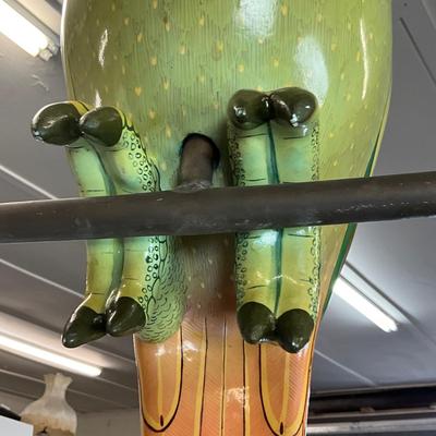Sale Photo Thumbnail #194: Made of thick heavy papier-mâché with thick gloss and paint placed on copper perch 
Estimated $1200-$2000
measures 32" high from beak to tail 
body width is 9" 
body depth is 23" (beak to body)
perch is 22.5" wide x 26.5" high (copper) 
bottom of tail h