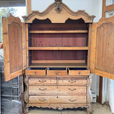Sale Photo Thumbnail #243: Has spotted black molds, seven drawers, three shelves, hand carved face motif, floral wallpaper, top comes apart in three sections
Measures: 7'6" high x 56" wide x 21.5" deep