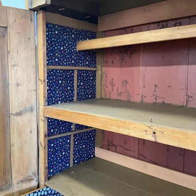 Sale Photo Thumbnail #242: Has spotted black molds, seven drawers, three shelves, hand carved face motif, floral wallpaper, top comes apart in three sections
Measures: 7'6" high x 56" wide x 21.5" deep