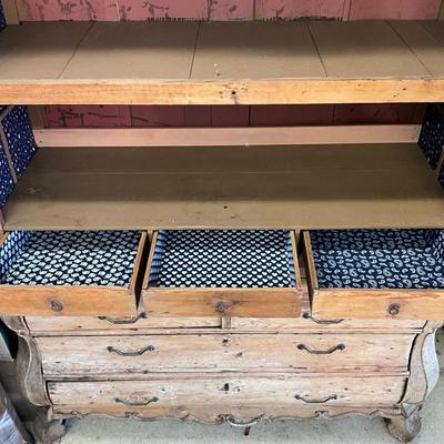 Sale Photo Thumbnail #251: Has spotted black molds, seven drawers, three shelves, hand carved face motif, floral wallpaper, top comes apart in three sections
Measures: 7'6" high x 56" wide x 21.5" deep