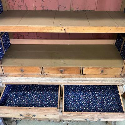 Sale Photo Thumbnail #250: Has spotted black molds, seven drawers, three shelves, hand carved face motif, floral wallpaper, top comes apart in three sections
Measures: 7'6" high x 56" wide x 21.5" deep