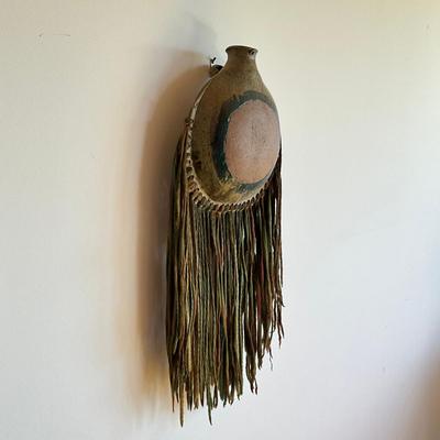 Sale Photo Thumbnail #464: 25" inches from top to bottom of tassels
pottery round wall vase with multi colored yarn 
no signatures