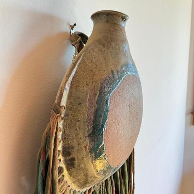 Sale Photo Thumbnail #463: 25" inches from top to bottom of tassels
pottery round wall vase with multi colored yarn 
no signatures