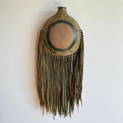 Sale Photo Thumbnail #461: 25" inches from top to bottom of tassels
pottery round wall vase with multi colored yarn 
no signatures