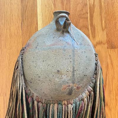Sale Photo Thumbnail #462: 25" inches from top to bottom of tassels
pottery round wall vase with multi colored yarn 
no signatures