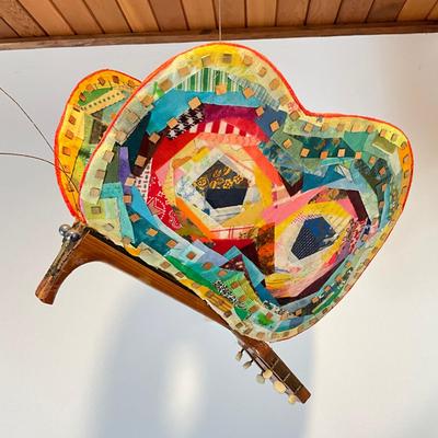 Sale Photo Thumbnail #486: Measures: 22.5" long x 14" wide x 17" high
Guitar wings have a collage mixed materials.