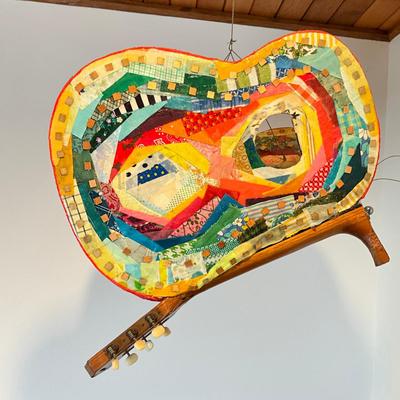 Sale Photo Thumbnail #490: Measures: 22.5" long x 14" wide x 17" high
Guitar wings have a collage mixed materials.