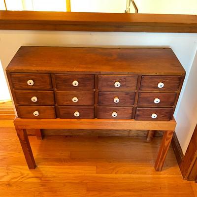 Sale Photo Thumbnail #500: Has been placed on a pine stand
Porcelain knobs
Measures: 33" wide x 11.5" deep x 28.5" high