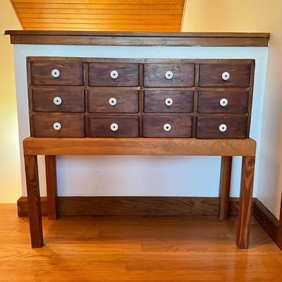 Sale Photo Thumbnail #497: Has been placed on a pine stand
Porcelain knobs
Measures: 33" wide x 11.5" deep x 28.5" high