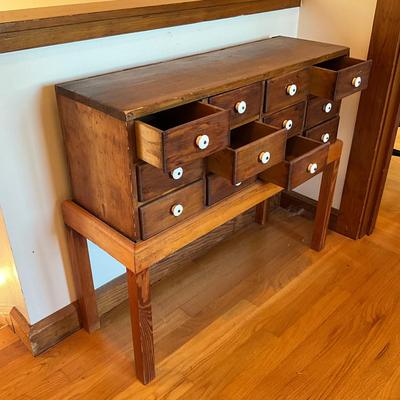 Sale Photo Thumbnail #498: Has been placed on a pine stand
Porcelain knobs
Measures: 33" wide x 11.5" deep x 28.5" high