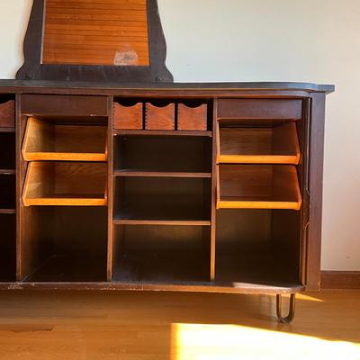 Sale Photo Thumbnail #546: Has adjustable shelves, has damage to front right and left corner, top is solid slate
Piece of veneer on the left bottom corner is coming off and it seems the feet have been replaced and are the original. Please refer to photos.
Measures: 6'7.5" wide x 22