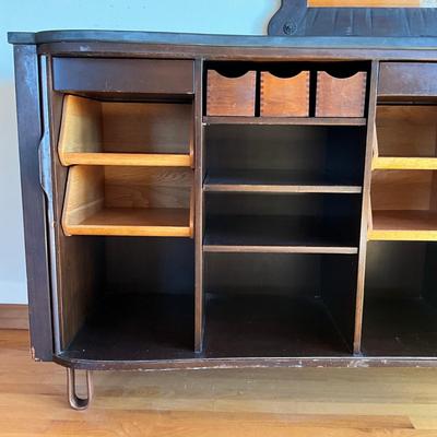 Sale Photo Thumbnail #547: Has adjustable shelves, has damage to front right and left corner, top is solid slate
Piece of veneer on the left bottom corner is coming off and it seems the feet have been replaced and are the original. Please refer to photos.
Measures: 6'7.5" wide x 22