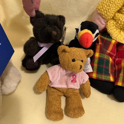 Sale Photo Thumbnail #568: Lot of Mixed Stuffed Animals- from new to gently loved. Hugs & Cuddles dog, breast cancer bear, Beanie Baby Penguin, Hedgehog, and what appears to be a handmade and knitted friend.