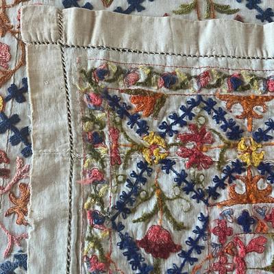 Sale Photo Thumbnail #1144: Has a few holes due to age ( refer to photos)
Intricate embroidery with pink, orange, green, blue and brown colors
Measures: 62" wide x 98" long