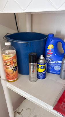 A BUCKET AND AN ARRAY OF DIFFERENT CLEANING PRODUCTS