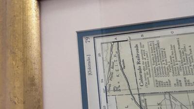 64/100 BARBARA MOORE FRAMED ARTWORK AND 1979 FRAMED COMMERCIAL ATLAS MAP OF COLORFUL COLORADO