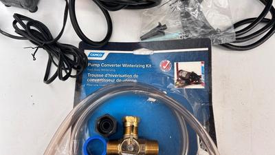 AN ASSORTMENT OF DIFFERENT PUMPS FOR PONDS AND AN OUTDOOR EXTENSION CORD