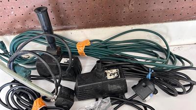 AN ASSORTMENT OF DIFFERENT PUMPS FOR PONDS AND AN OUTDOOR EXTENSION CORD
