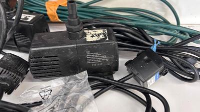 AN ASSORTMENT OF DIFFERENT PUMPS FOR PONDS AND AN OUTDOOR EXTENSION CORD