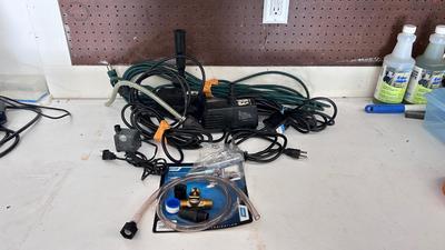AN ASSORTMENT OF DIFFERENT PUMPS FOR PONDS AND AN OUTDOOR EXTENSION CORD