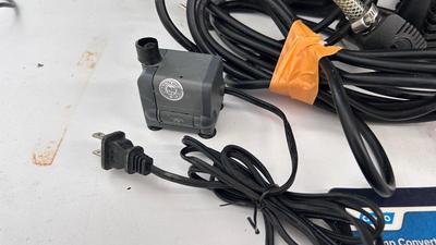 AN ASSORTMENT OF DIFFERENT PUMPS FOR PONDS AND AN OUTDOOR EXTENSION CORD