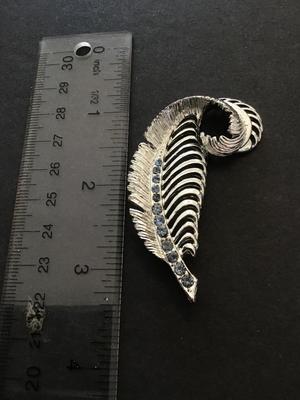 Silver tone leaf brooch with light blue rhinestones