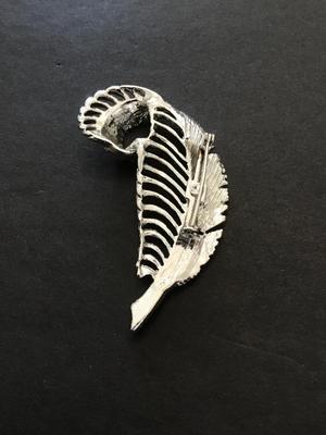 Silver tone leaf brooch with light blue rhinestones
