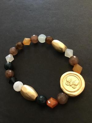 Pretty multicored beaded bracelet with gold tone butterfly charm