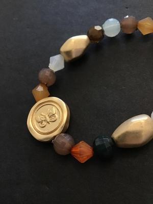 Pretty multicored beaded bracelet with gold tone butterfly charm