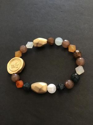 Pretty multicored beaded bracelet with gold tone butterfly charm