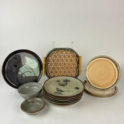 Sale Photo Thumbnail #1429: Two bowls, three plates (9.5" diameter) signed Moodie, 1-handled cane/pottery edge tray (11.5" square), 1 dinner plate (11" diameter), 6 mexico pottery bird plates
Some have chipping damage