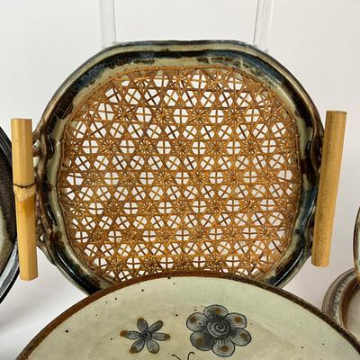 Sale Photo Thumbnail #1435: Two bowls, three plates (9.5" diameter) signed Moodie, 1-handled cane/pottery edge tray (11.5" square), 1 dinner plate (11" diameter), 6 mexico pottery bird plates
Some have chipping damage