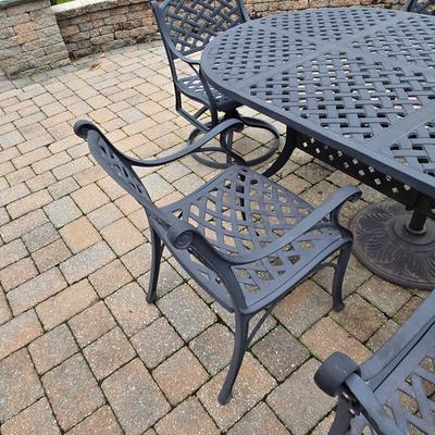 LOT 282: Oval Metal Outdoor Table with 2 Swivel Chairs, 4 Stationary Chairs, and Umbrella Stand