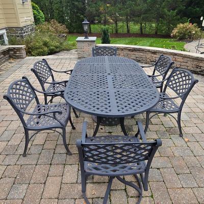 LOT 282: Oval Metal Outdoor Table with 2 Swivel Chairs, 4 Stationary Chairs, and Umbrella Stand