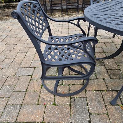 LOT 282: Oval Metal Outdoor Table with 2 Swivel Chairs, 4 Stationary Chairs, and Umbrella Stand