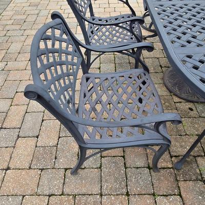 LOT 282: Oval Metal Outdoor Table with 2 Swivel Chairs, 4 Stationary Chairs, and Umbrella Stand