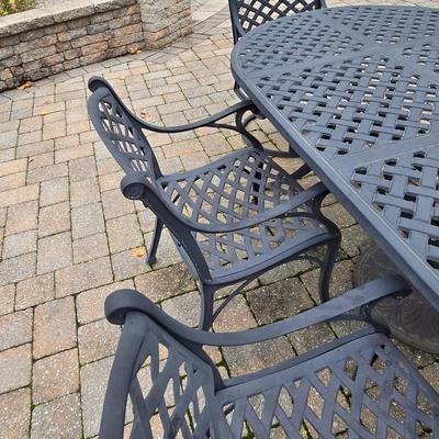 LOT 282: Oval Metal Outdoor Table with 2 Swivel Chairs, 4 Stationary Chairs, and Umbrella Stand