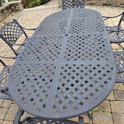 LOT 282: Oval Metal Outdoor Table with 2 Swivel Chairs, 4 Stationary Chairs, and Umbrella Stand