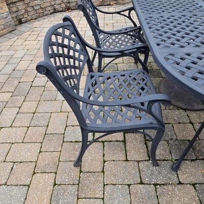 LOT 282: Oval Metal Outdoor Table with 2 Swivel Chairs, 4 Stationary Chairs, and Umbrella Stand