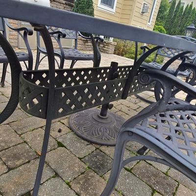 LOT 282: Oval Metal Outdoor Table with 2 Swivel Chairs, 4 Stationary Chairs, and Umbrella Stand