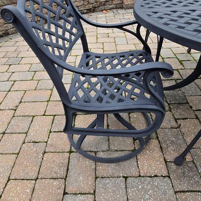 LOT 282: Oval Metal Outdoor Table with 2 Swivel Chairs, 4 Stationary Chairs, and Umbrella Stand