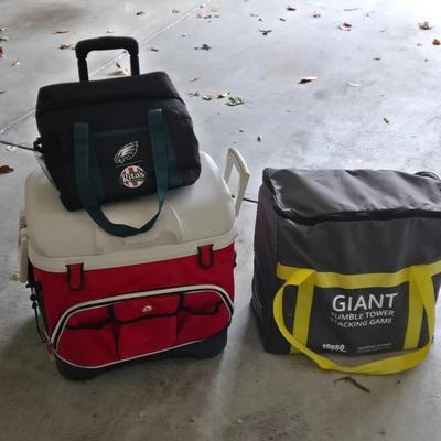 LOT 291G: Giant Tumble Tower Stacking Game, Igloo Cooler with Wheels and Handle, and Small Soft Cooler