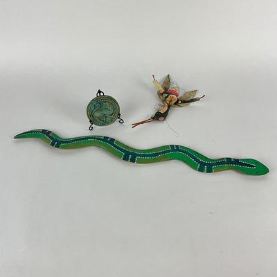 Sale Photo Thumbnail #1505: Painted wooden snake, small clay medallion signed on back 1997 and hand-made doll
Snake: 25" long
Doll: 10" high
Medallion: 3.5" diameter