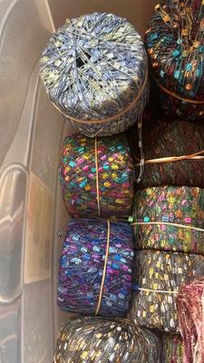 A TOTE PACKED WITH A BUNCH OF CRAFTING STRING/THREAD