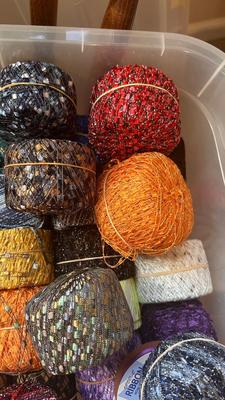 A TOTE PACKED WITH A BUNCH OF CRAFTING STRING/THREAD