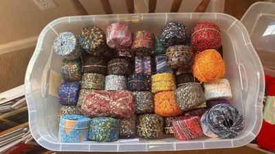 A TOTE PACKED WITH A BUNCH OF CRAFTING STRING/THREAD