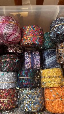 A TOTE PACKED WITH A BUNCH OF CRAFTING STRING/THREAD